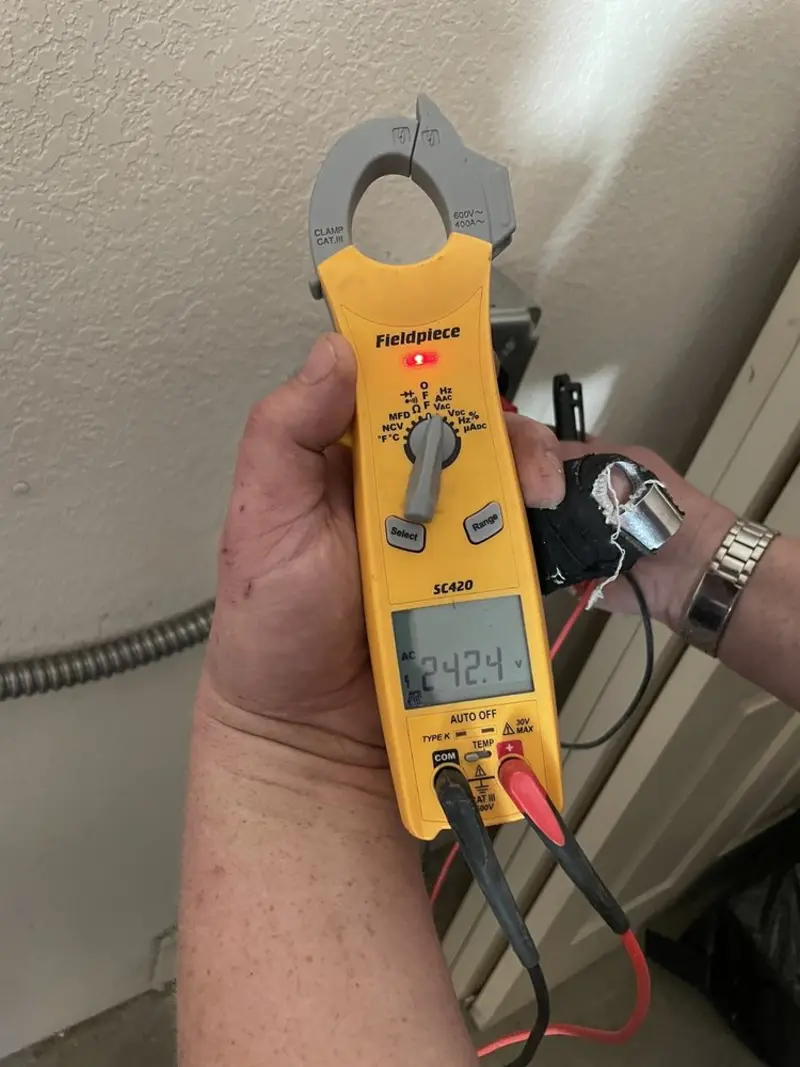 Voltage testing with clamp meter during Outlet Installation in Santa Teresa